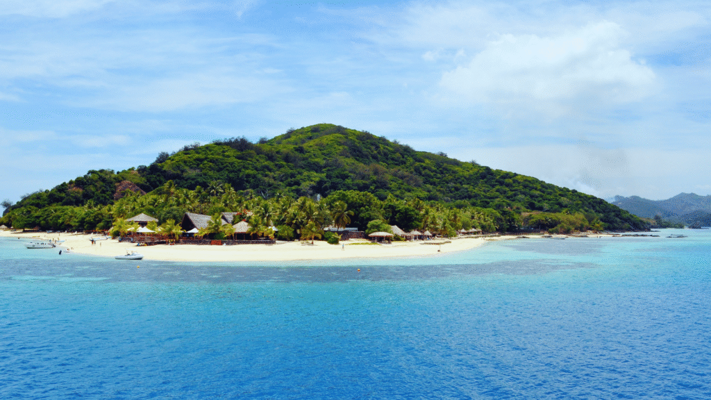 Crystal-clear waters, white sandy beach, and boats near the Gili Islands, Indonesia – a tropical travel paradise and one of the Top 10 Asian Beaches

