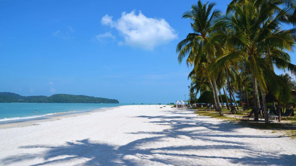 Pristine sandy beach with turquoise water and lush greenery at Langkawi, Malaysia – a popular travel destination and one of the Top 10 Asian Beaches

