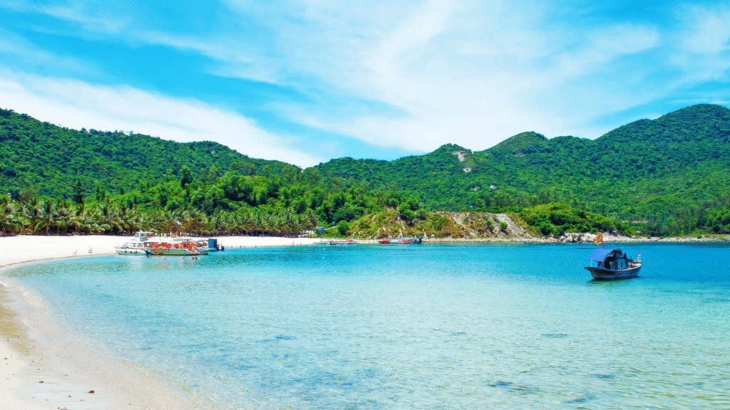 Panoramic view of Nha Trang Beach in Vietnam with palm trees, white sand, and coastal skyline – a leading travel destination and one of the Top 10 Asian Beaches

